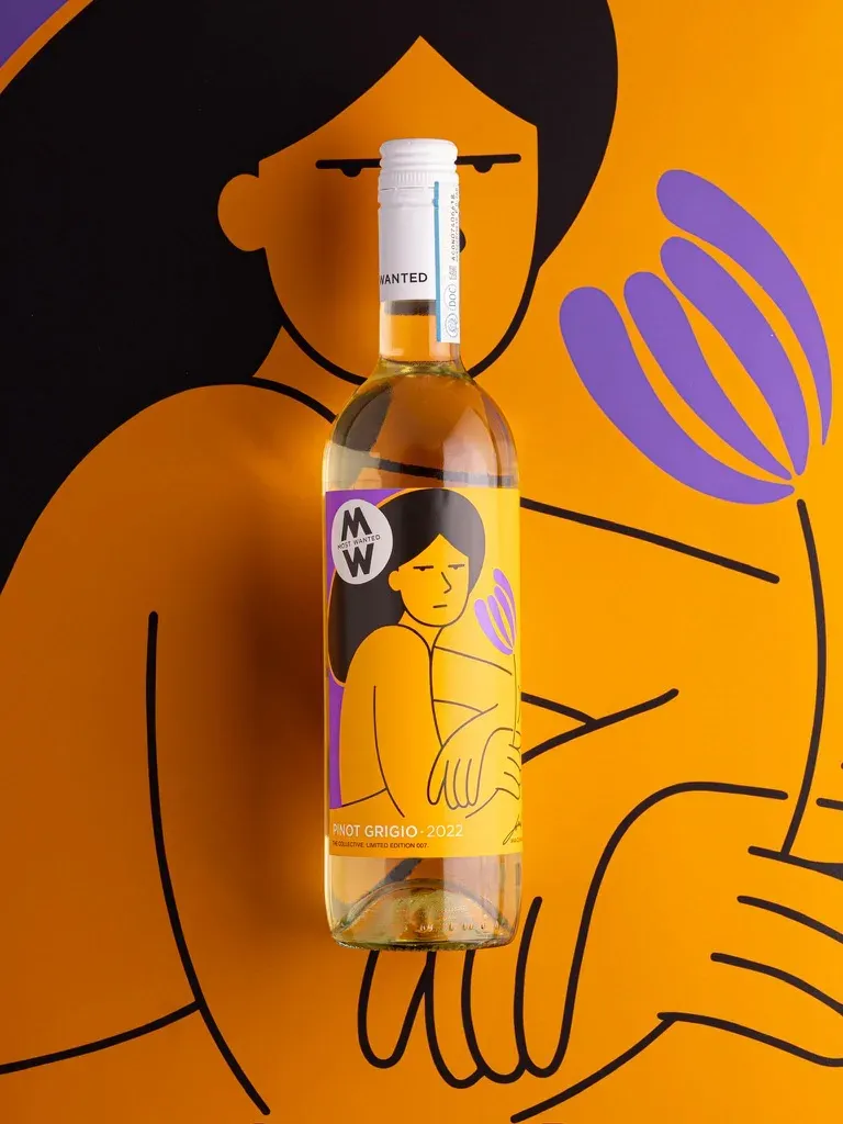 The Most Wanted Pinot Grigio bottle lying on the full-size artwork.