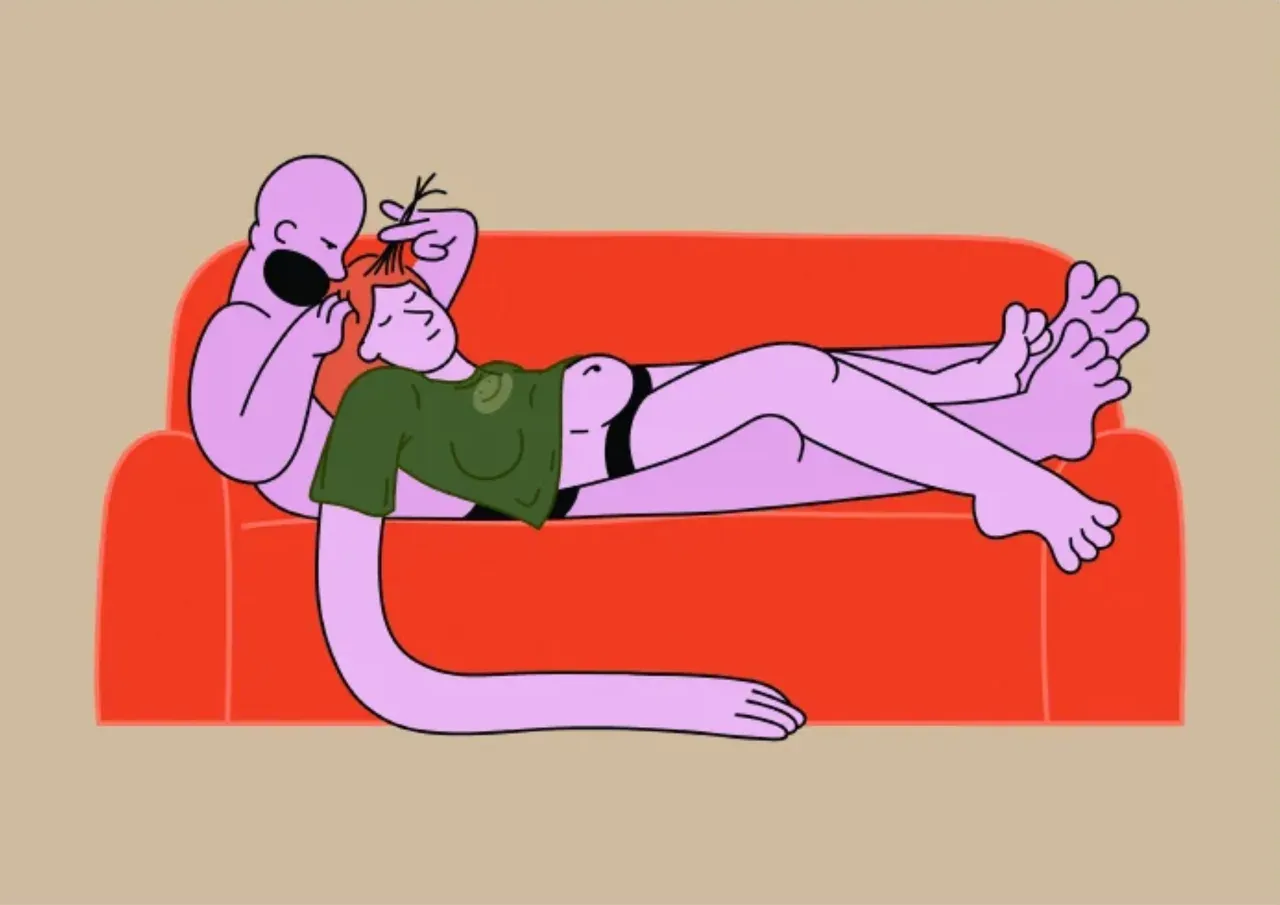 Two lilac figures curled up together on an orange sofa.